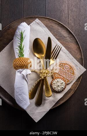 Christmas table place setting with vintage silverware and gingerbread. Christmas dining concept background Stock Photo