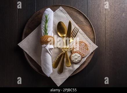 Christmas table place setting with vintage silverware and gingerbread. Christmas dining concept background Stock Photo