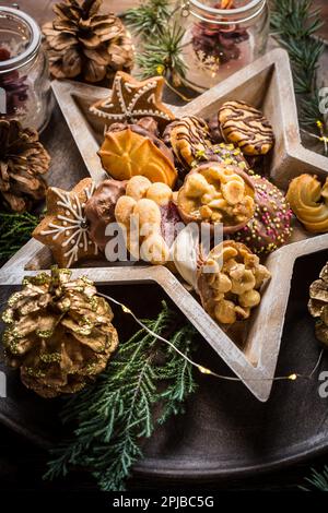 Variation of Christmas cookies and gingerbread with ornaments on wooden background Stock Photo