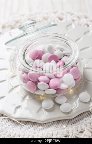 White and pink chocolate lentils with peppermint flavor in glass Stock Photo