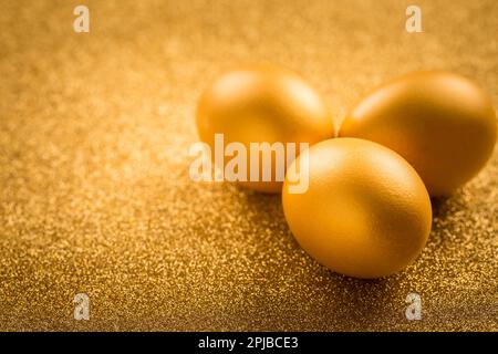 Golden eggs on golden background for Easter Stock Photo