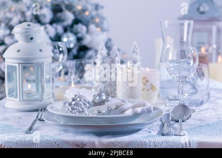 Festive Christmas table or place setting in snowy white Stock Photo