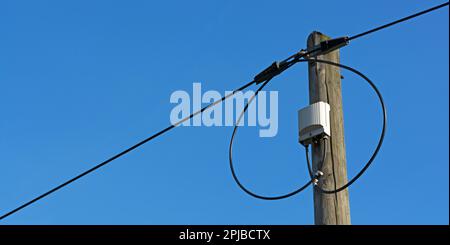 DSL overhead line with blue sky in background Stock Photo