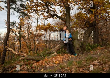 A mother with a child and a dog are walking along the mountain hiking trail. Family spending time. Polish mountains, Poland, Europe Stock Photo