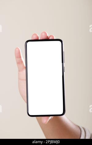 Front view of blank screen smartphone in hand on grey background Stock Photo
