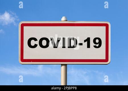 A French enter city sign against a blue sky with written in COVID-19 in the middle. Stock Photo