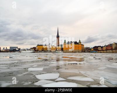 View of the city of Gamla Stan in Stockholm (Sweden) during winter with the frozen river Stock Photo