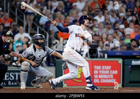 Houston Astros' Jeremy Pena, right, slides to score as Texas Rangers  catcher Jonah Heim, left, waits for the throw on a sacrifice fly by Yanier  Diaz during the fourth inning of a