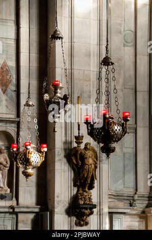 Meant to depict the presence of Christ, traditional hanging sanctuary lamps in Como Cathedral in Como, Italy. Stock Photo