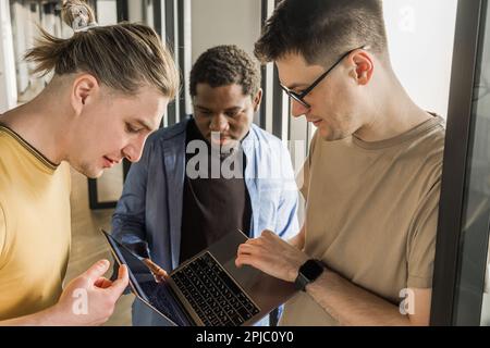 Team is looking for bug fixes in the phone application. Programmers working in the office of a software development company. Coding technologies, site Stock Photo