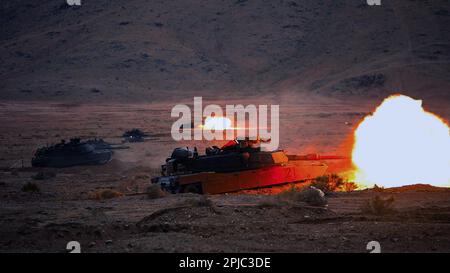 U.S. Army Soldiers assigned to the 'Spartan Brigade,' 2nd Armored Brigade Combat Team, 3rd Infantry Division, fire from a modernized M1A2 SEPv3 Abrams tanks at the National Training Center, Fort Irwin, California, March 10, 2023. The Spartan Brigade, the Army’s most modernized brigade, completed its rotation NTC 23-05, making it not only the best equipped but most lethal unit in America’s arsenal as the Army moves toward building the Army of 2030.(U.S. Army photo by Sgt. Dre Stout, 50th Public Affairs Detachment) Stock Photo