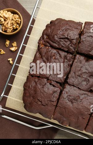 Delicious freshly baked brownies and walnuts on wooden table, flat lay Stock Photo