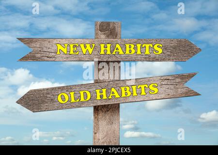 Signpost with two opposite directions to Old and New Habits outdoors Stock Photo