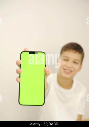 boy holding phone mockup in vertical position. Person using smartphone for showing photo or information. empty screen. High quality photo. High quality photo Stock Photo
