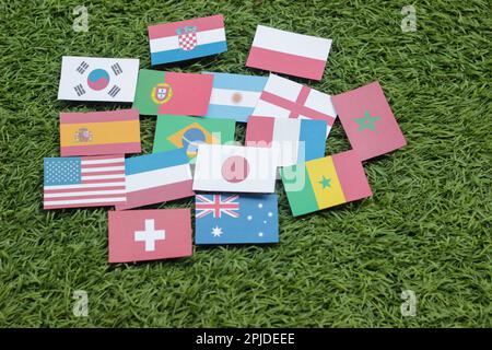 Leather soccer ball with international team flags of the participating countries in the championship tournament isolated on white background. Football Stock Photo