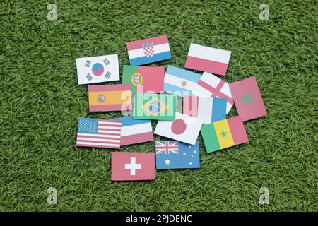 Leather soccer ball with international team flags of the participating countries in the championship tournament isolated on white background. Football Stock Photo