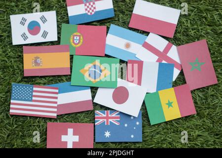 Leather soccer ball with international team flags of the participating countries in the championship tournament isolated on white background. Football Stock Photo