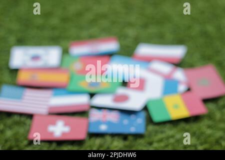 Leather soccer ball with international team flags of the participating countries in the championship tournament isolated on white background. Football Stock Photo