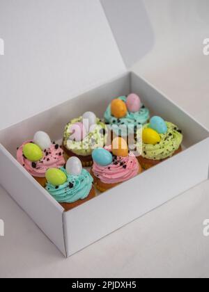 easter pastel handmade group of muffins with confetti chocolate eggs on top Stock Photo