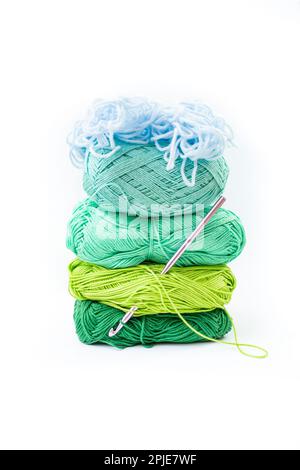 Gradient colored yarn spools stack, cold colors thread coils isolated on white Stock Photo
