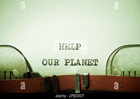 Help our planet text written with a typewriter. Stock Photo