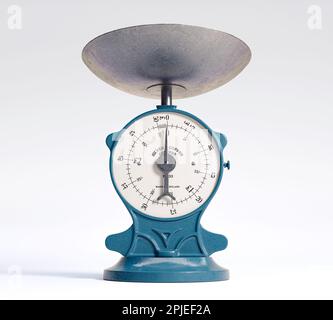 A vintage cast iron weight scale on a white isolated background - 3D render Stock Photo