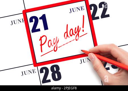 21st day of June. Hand writing text PAY DATE on calendar date June 21 and underline it. Payment due date.  Reminder concept of payment. Summer month, Stock Photo