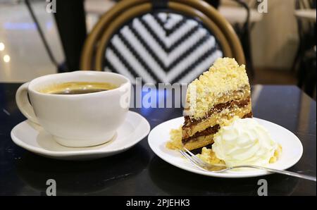 Flavorful banoffee pie cake with a cup of black coffee served on the table Stock Photo