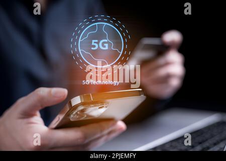 Close up of hand holding smartphone with high speed internet 5G Stock Photo