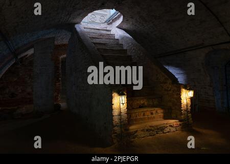 Dark basement of an old antique building. Staircase in the dungeon of the Cathedral of the Nativity of the Blessed Virgin Mary, Glubokoe, Belarus. Stock Photo