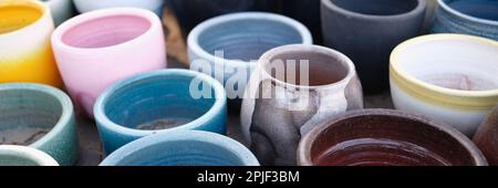 Old clay colorful pots on wooden floor Stock Photo