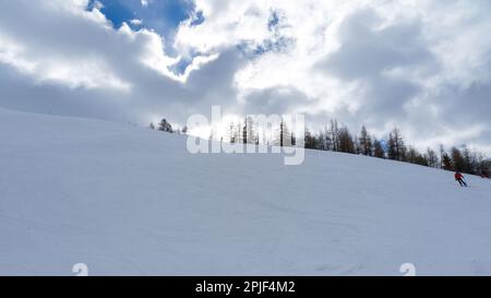 View of a snowy landscape with clouds in the sky Stock Photo