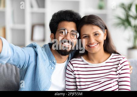 Portrait of loving happy beautiful mixed race couple, home interior Stock Photo