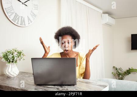 a African American Black Woman Portrait House. Indoor, woman is surprised, stunned, angry, mouth open. Winning, bug, laptop broken, lottery, job vacan Stock Photo