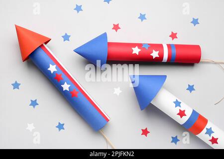 Firework rockets with stars for Independence Day on light background Stock Photo