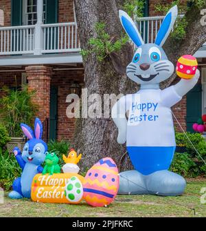 NEW ORLEANS, LA, USA - APRIL 1, 2023: Inflated Easter bunnies, eggs, frog and chick decorate the front lawn of an Uptown building Stock Photo
