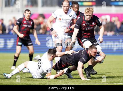 Saracens Ben Earl is tackled by Ospreys Owen Watkins during the Heineken Champions Cup round of 16 match at the StoneX Stadium, London. Picture date: Sunday April 2, 2023. Stock Photo