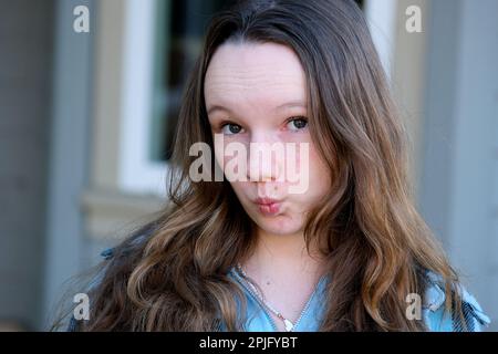 Premium Photo | A pensive doubting young woman pursed her lips and looks  suspiciously to the side