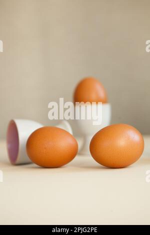 brown easter eggs on the table. Eggs chicken on beige background Stock Photo