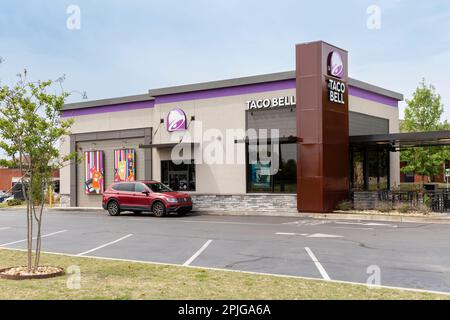 Car at drive-thru fast food restaurant Taco Bell showing the corporate logo and current design in Montgomery, Alabama USA. Stock Photo