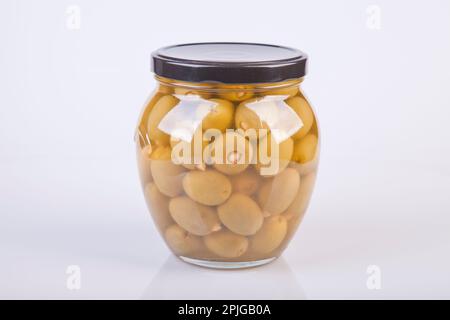 Jar of almond stuffed green olives on a white background. Jar of garlic stuffed olives isolated on white. Stock Photo