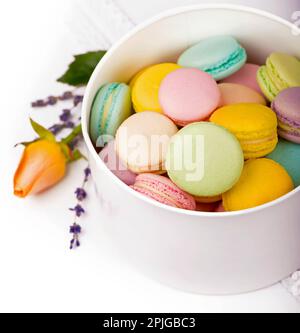 Colorful macaroons in a gift box on a white table Stock Photo
