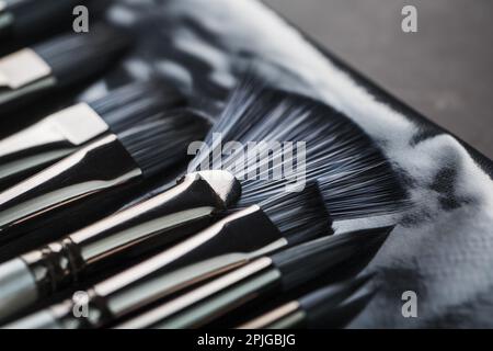 A set of art brushes for drawing on a black background, Close-up Stock Photo