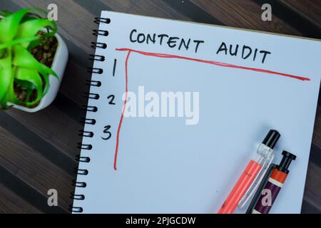 Concept of Content Audit write on book, Supported by an additional services isolated on Wooden Table. Stock Photo