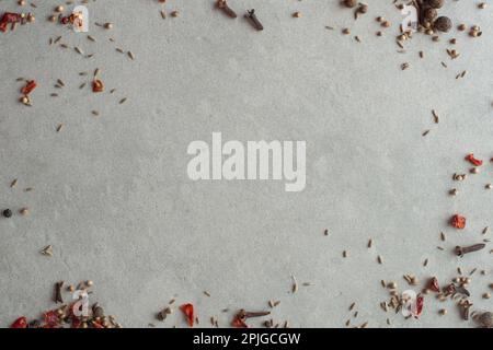 Spices scattered on a gray background, top view Stock Photo