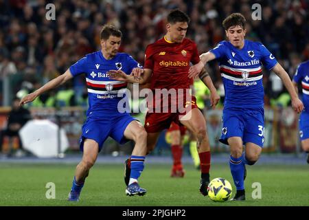 Rome, Italy. 02nd Apr, 2023. Paulo Dybala, center, of AS Roma, is challenged by Filip Djuricic, left, and Flavio Paoletti, of Sampdoria, during the Serie A football match between Roma and Sampdoria at Rome's Olympic stadium, Rome, Italy, April 2, 2023. Credit: Riccardo De Luca - Update Images/Alamy Live News Stock Photo