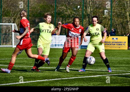 Teesside, UK. 02 Apr 2023. Middlesbrough Women FC striker Armani Maxwell shrugs off two Stockport defenders as Middlesbrough Women FC (in red and white) played Stockport County Ladies FC in the FA Women’s National League Division One North. The visitors won 1-6 at the Map Group UK Stadium in Stockton-on-Tees - a scoreline which was harsh on the home side. Credit: Teesside Snapper/Alamy Live News Stock Photo