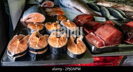 Salmon cutlets and tuna meat on sale in the fish market in Quarteira, Portugal. Stock Photo