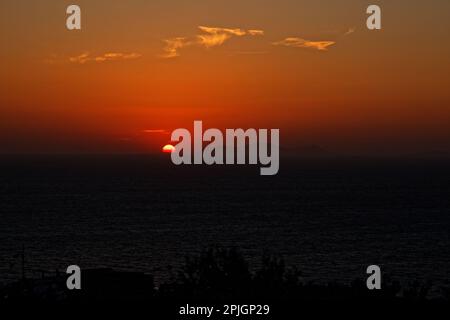The setting sun as seen from Oia, Santorini, Greece Stock Photo