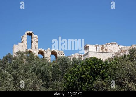 Ancient ruins atop the Acropolis behind a tree line Stock Photo
